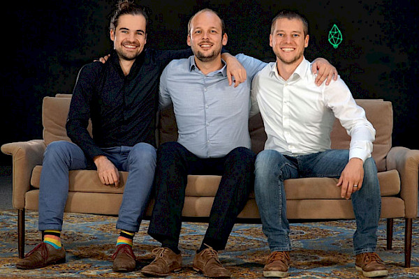 The three founders of greenventory on a sofa