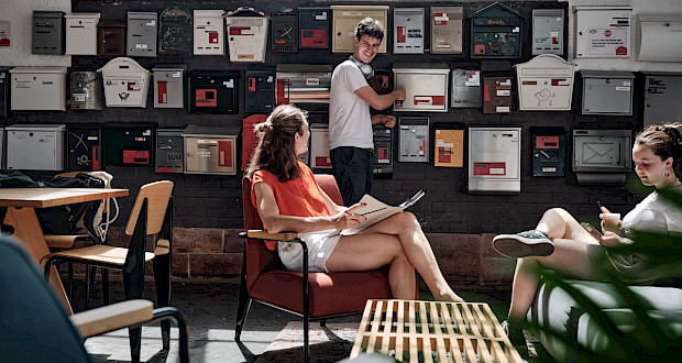 Community area in the entrance hall with mailboxes at Grünhof Freiburg