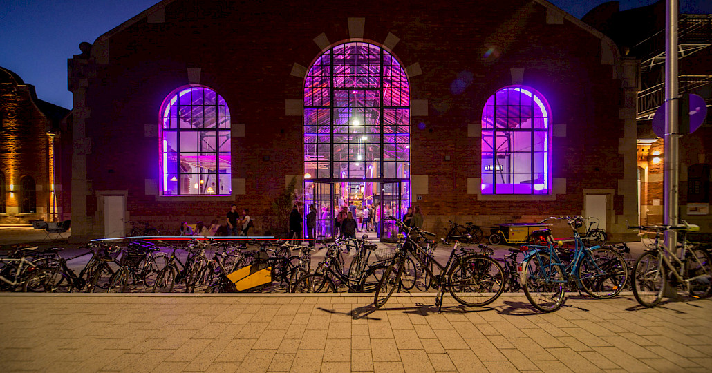 Purple illuminated locomotive hall at night