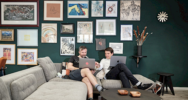 Coworkers sitting on the sofa and working