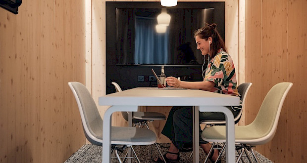 Woman holding a meeting in a meeting pod