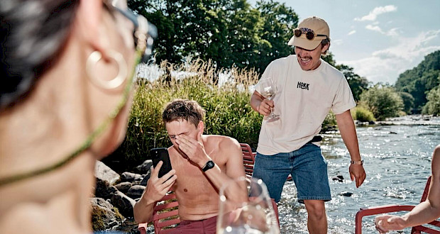 People with wine in the Dreisam at Hokk