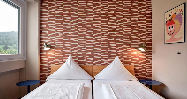 Stylish hotel room with double bed and view at Hokk Hotel