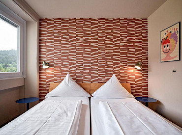 Stylish hotel room with double bed and view at Hokk Hotel